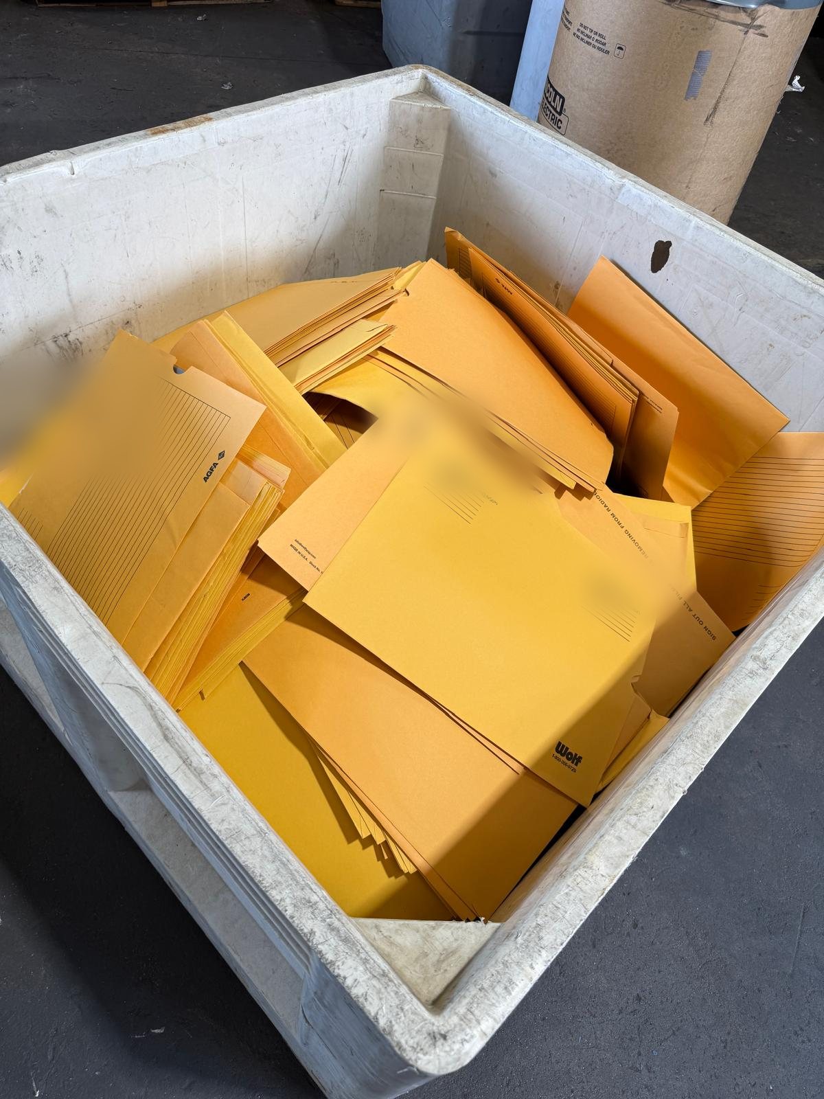 A bin filled with X-ray film jackets ready for pickup